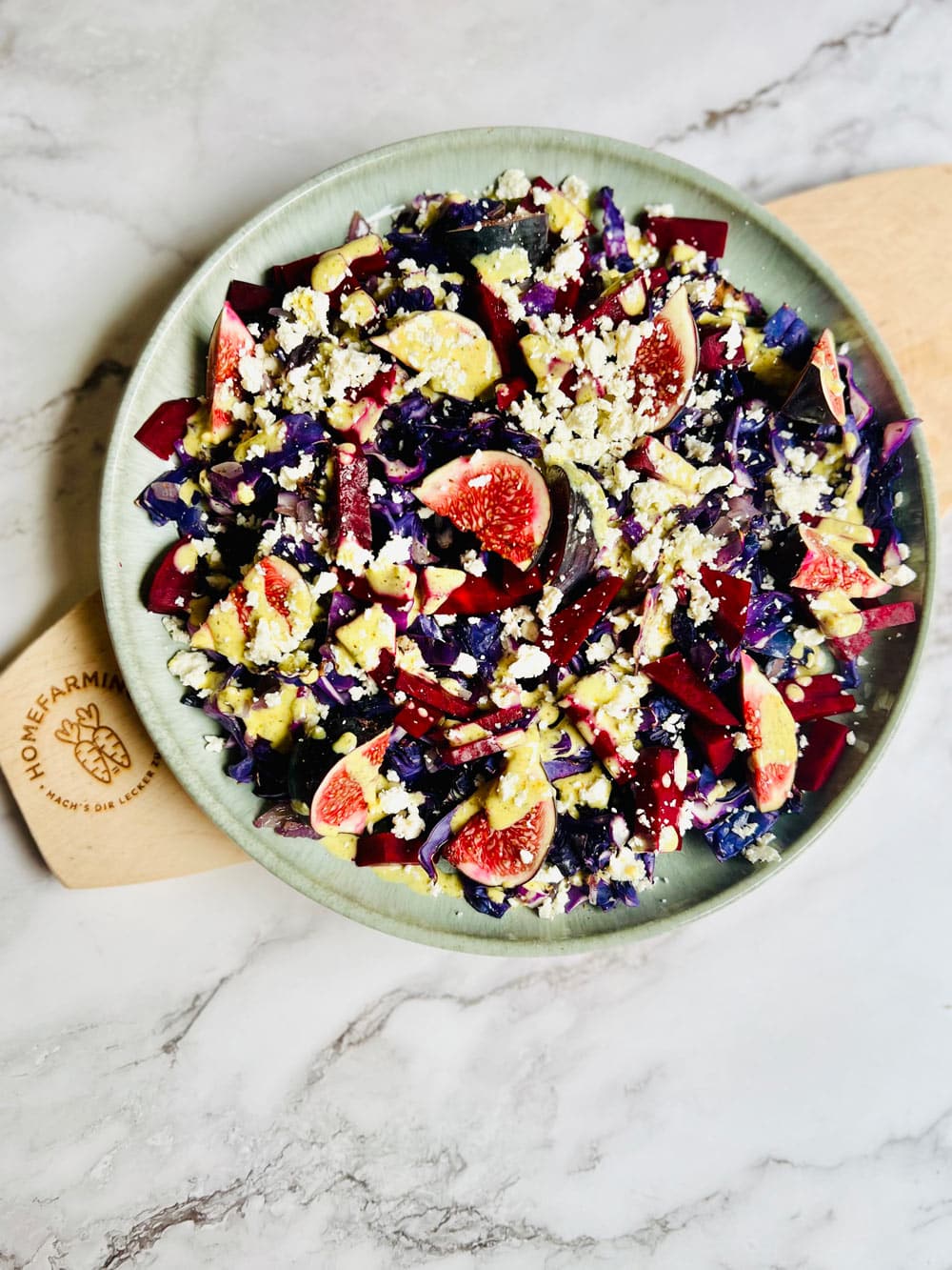 der Spitzkohl wird mit Dressing und Feta getoppt